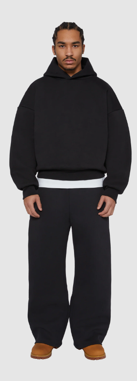 A man wearing a Seventh black night v2 hoodie