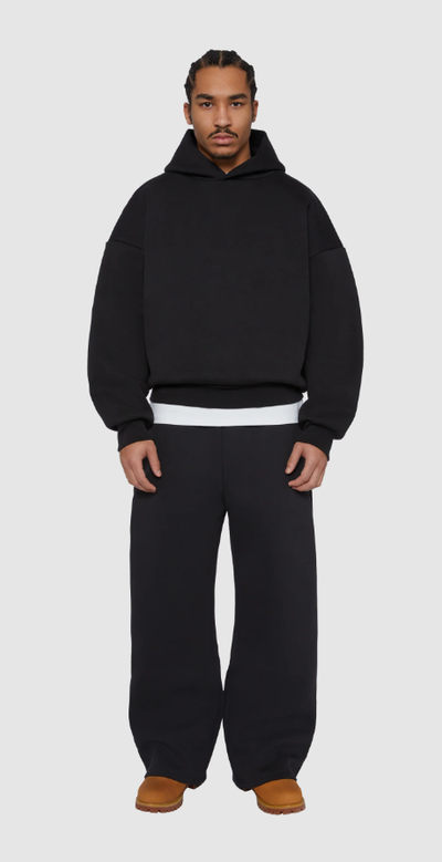 A man wearing a Seventh black night v2 hoodie