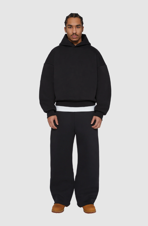 A man wearing a Seventh black night v2 hoodie
