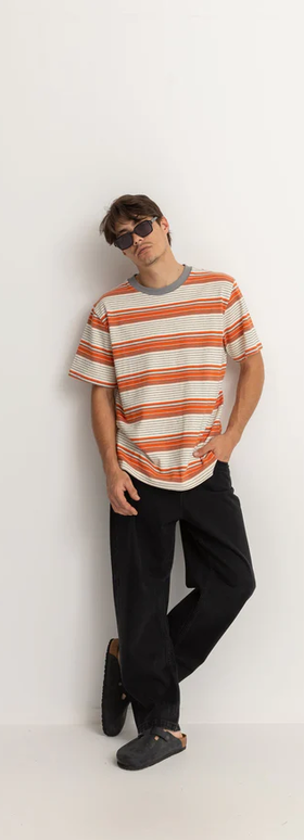 A man wearing a Rhythm vintage stripe ss t shirt