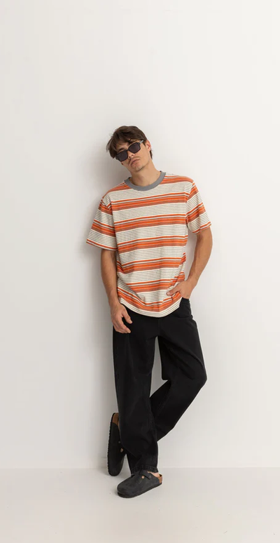 A man wearing a Rhythm vintage stripe ss t shirt