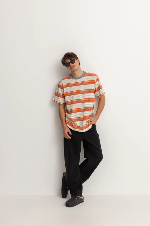 A man wearing a Rhythm vintage stripe ss t shirt