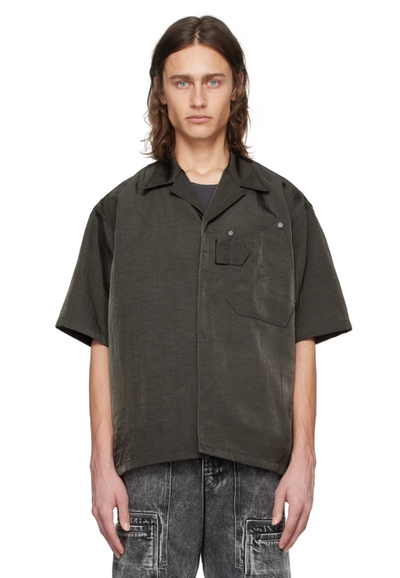 A man wearing a OUAT gray work shirt