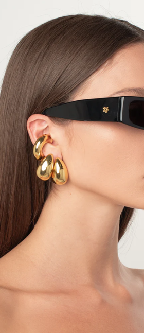 A woman wearing a ÉLIOU varsity ear cuff