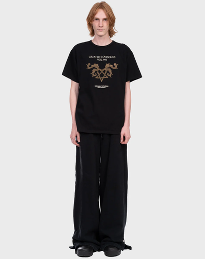 A man wearing a Midnight Studios greatest love songs t-shirt - black