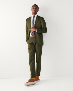 A man wearing a Cole Haan grandprø crew wingtip sneakers