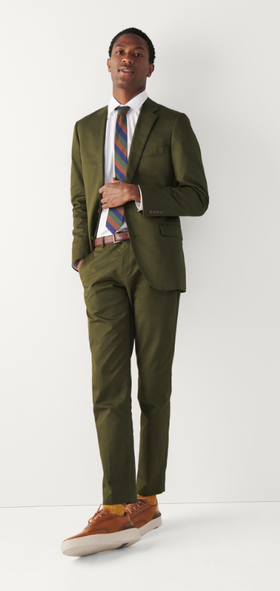 A man wearing a Cole Haan grandprø crew wingtip sneakers