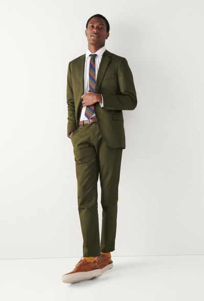 A man wearing a Cole Haan grandprø crew wingtip sneakers