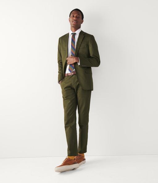 A man wearing a Cole Haan grandprø crew wingtip sneakers