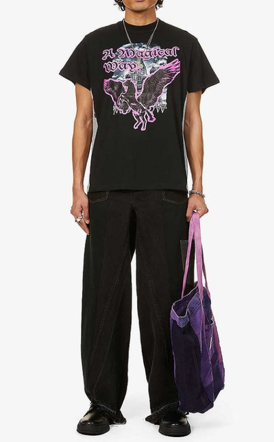 A man wearing a Liam Hodges magical way tee and black unified jeans