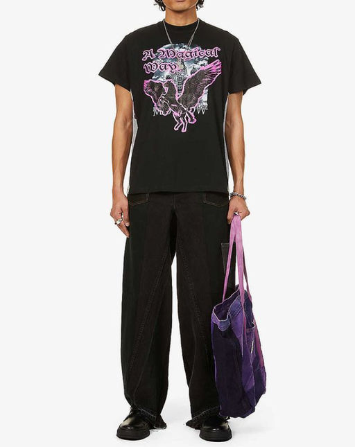 A man wearing a Liam Hodges magical way tee and black unified jeans