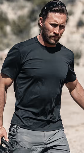A man wearing a Ten Thousand black tactical shirt