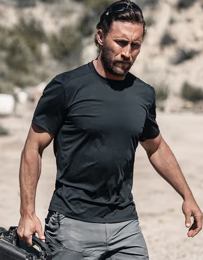 A man wearing a Ten Thousand black tactical shirt