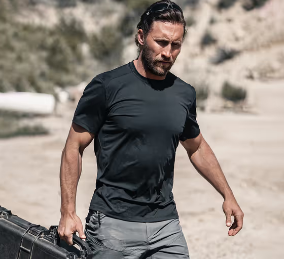 A man wearing a Ten Thousand black tactical shirt