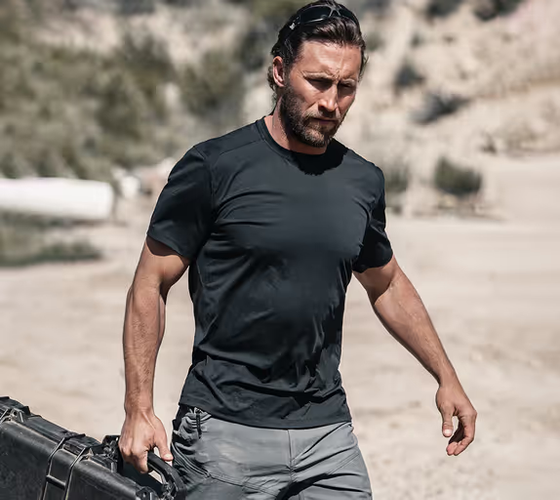 A man wearing a Ten Thousand black tactical shirt