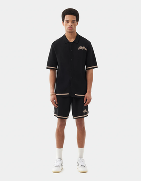 A man wearing a Filling Pieces knit shirt black