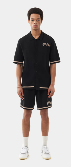A man wearing a Filling Pieces knit shirt black