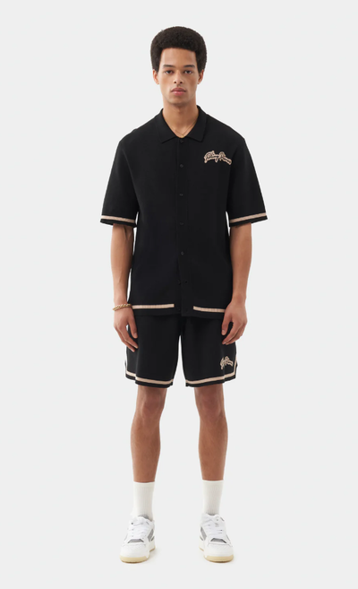 A man wearing a Filling Pieces knit shirt black
