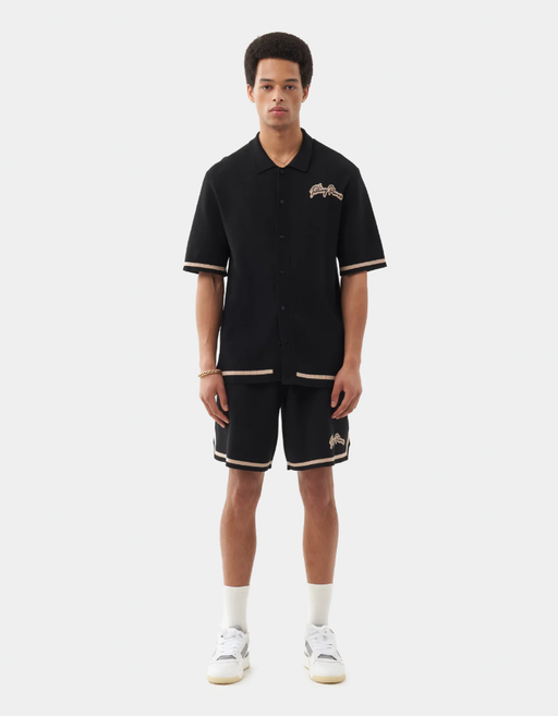 A man wearing a Filling Pieces knit shirt black