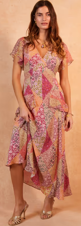 A woman wearing a Rixo evie silk midi dress