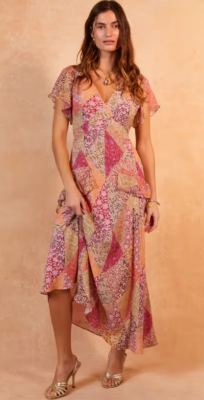 A woman wearing a Rixo evie silk midi dress