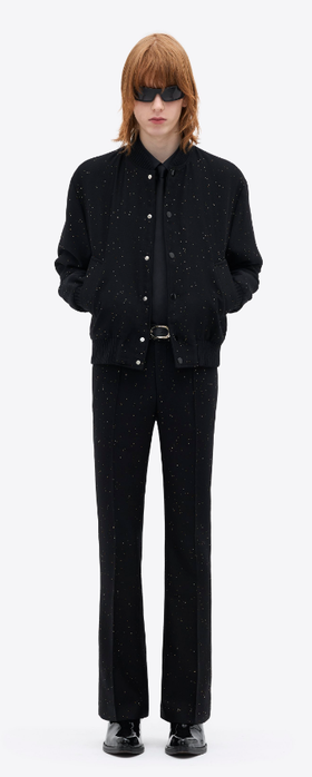 A man wearing a ERNEST W. BAKER gold sequin bomber