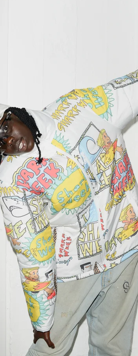 A man wearing a Shark Week NZ white printed puffy jacket