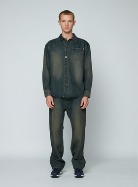 A man wearing a Wynn Hamlyn mens denim shirt - dirty wash