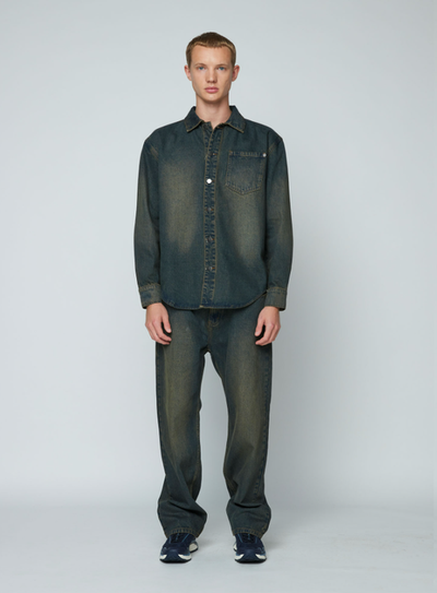 A man wearing a Wynn Hamlyn mens denim shirt - dirty wash
