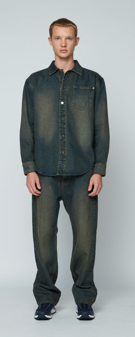 A man wearing a Wynn Hamlyn mens denim shirt - dirty wash