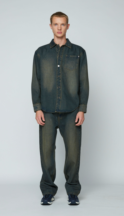 A man wearing a Wynn Hamlyn mens denim shirt - dirty wash