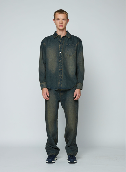 A man wearing a Wynn Hamlyn mens denim shirt - dirty wash
