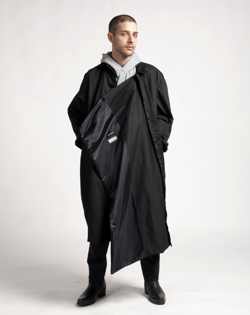 A man wearing Proudrace extended lining studio coat and deconstructed hoodie scarf