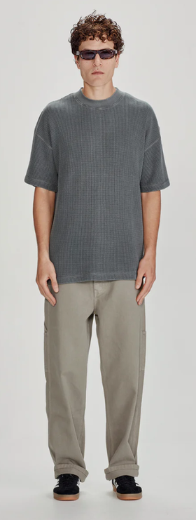 A man wearing a Commoners heavy waffle oversized tee, vintage stormy