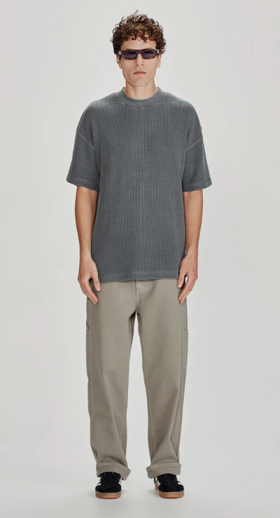 A man wearing a Commoners heavy waffle oversized tee, vintage stormy