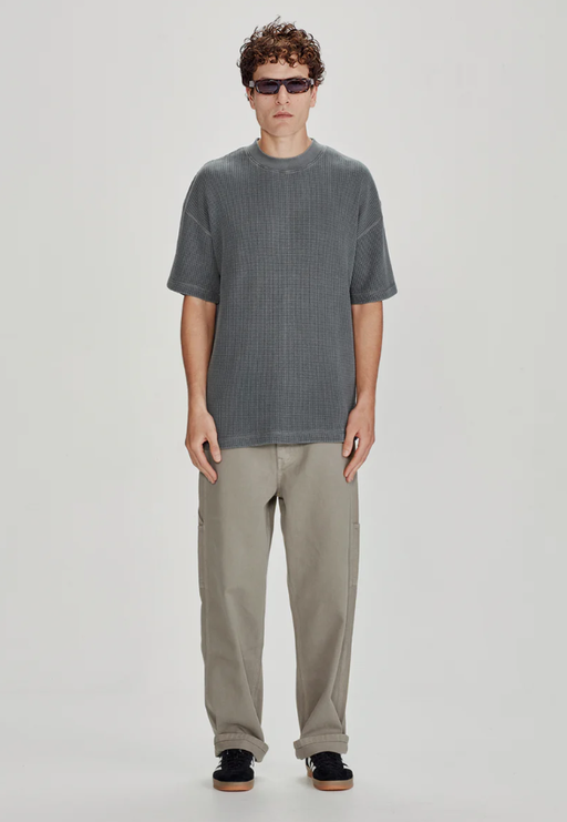A man wearing a Commoners heavy waffle oversized tee, vintage stormy