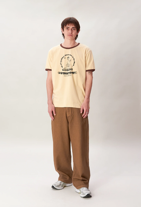 A man wearing a Checks New Zealand ringer t-shirt