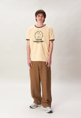 A man wearing a Checks New Zealand ringer t-shirt