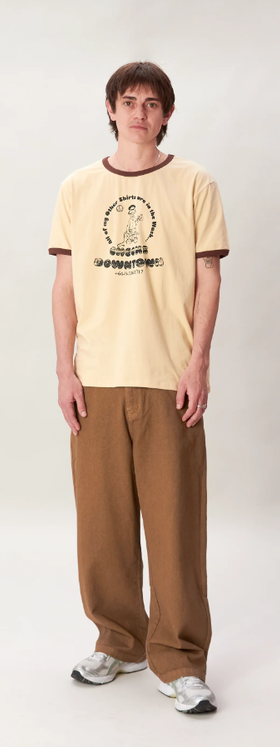 A man wearing a Checks New Zealand ringer t-shirt