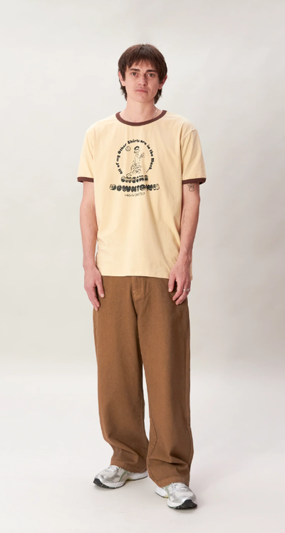 A man wearing a Checks New Zealand ringer t-shirt