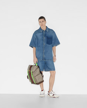 A man carrying Gucci Kids ophidia gg medium backpack