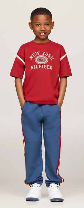 A boy wearing Tommy Hilfiger Kids embroidered varsity logo t-shirt