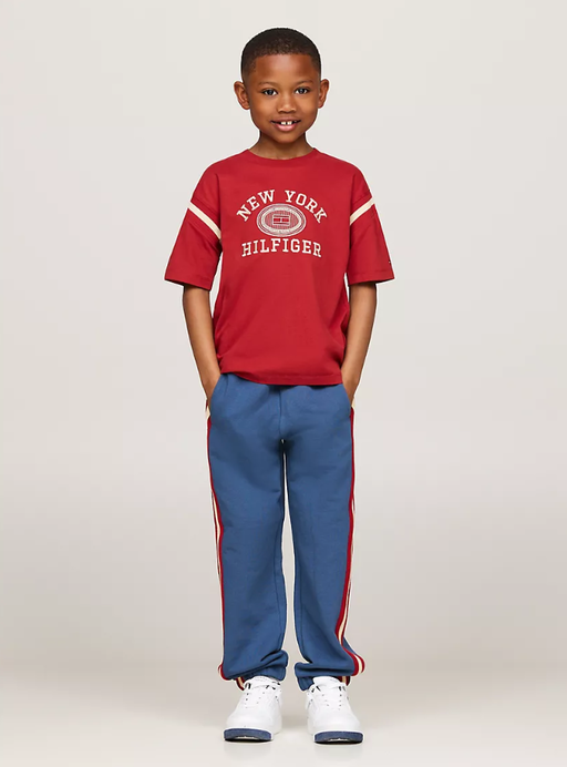 A boy wearing Tommy Hilfiger Kids embroidered varsity logo t-shirt