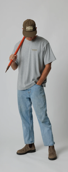 A man wearing a Moreporks grey mountain society tee