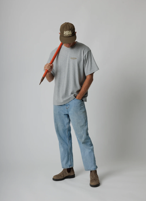 A man wearing a Moreporks grey mountain society tee
