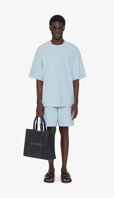 A man wearing Givenchy Kids t-shirt in 4g cotton towelling