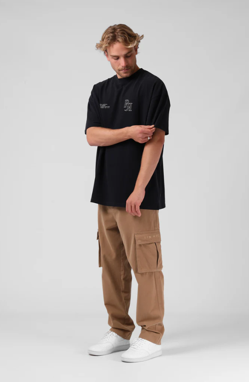 A man wearing a RPM street sanded os tee - vintage black