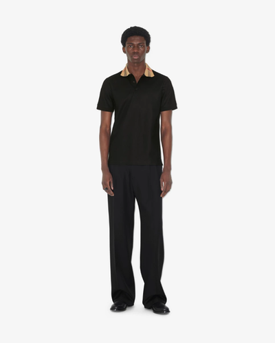 A man wearing Burberry Kids black cotton polo shirt