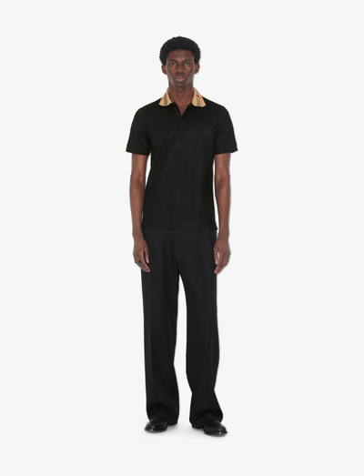 A man wearing Burberry Kids black cotton polo shirt