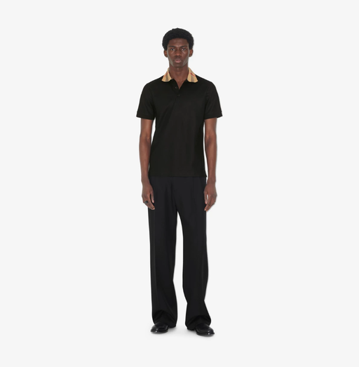 A man wearing Burberry Kids black cotton polo shirt